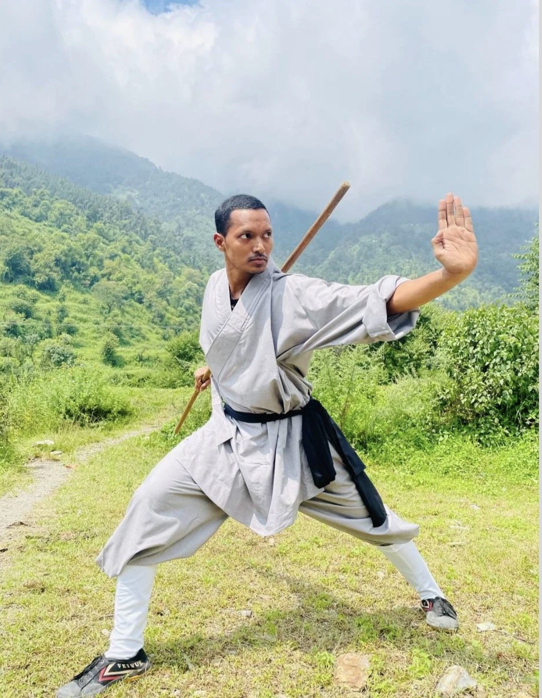 Sahil Attar practising a kung fu staff form
